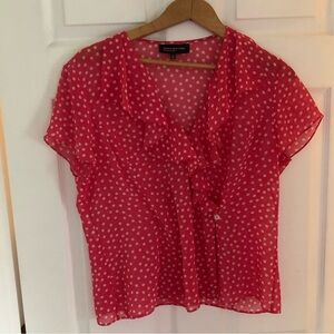 Polka dot blouse by Jones New York features a feminine ruffle-trimmed V-neck